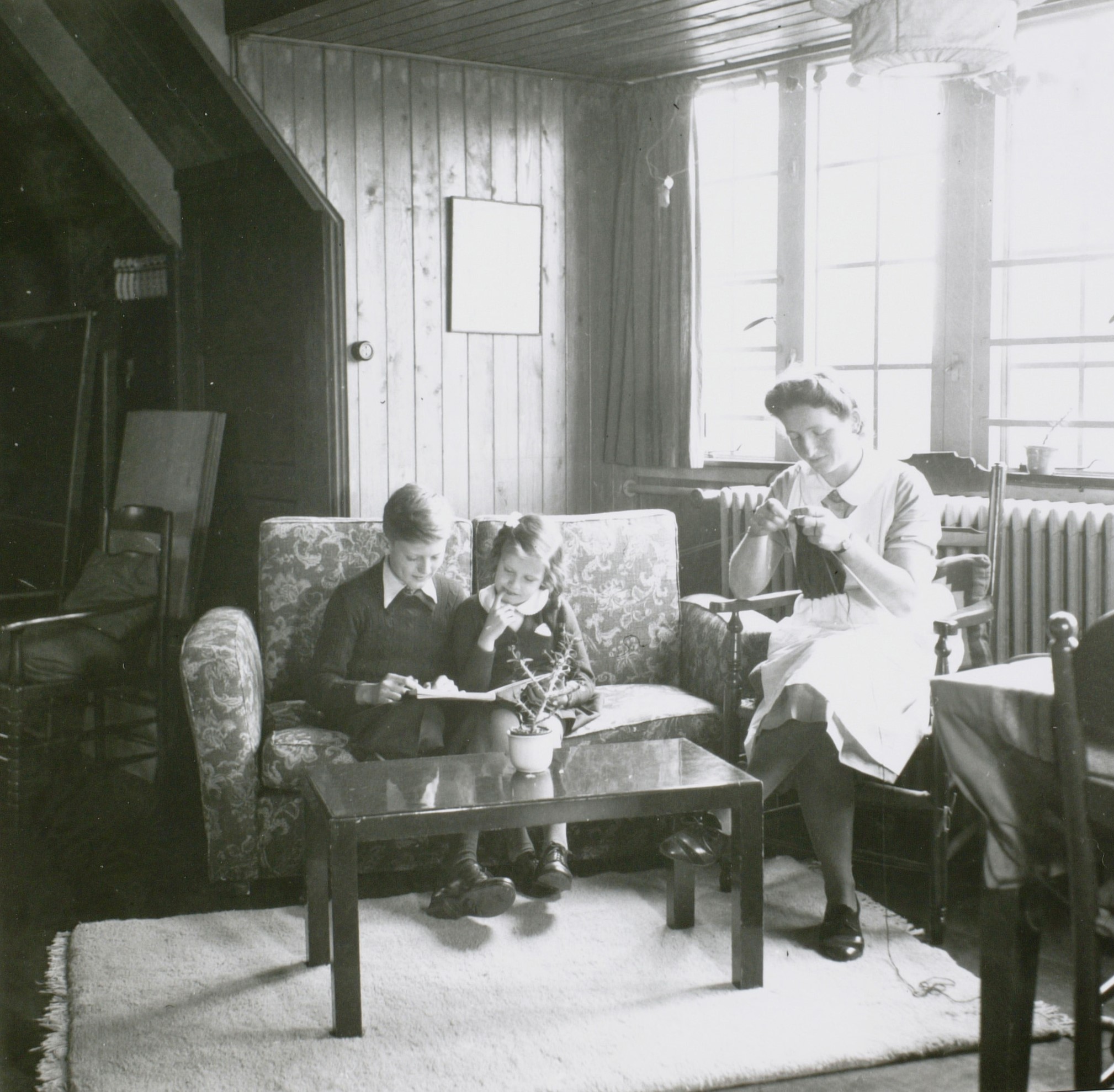 <em>Kinderen van F.G. Waller in de woonkamer, onder toeziend oog van hun verzorgster, 1941, foto Peter Odijk (objectnr. 18657)</em>